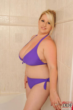 Fleshy blonde Janne Hollan soaps up her huge big tits in the shower